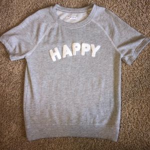 gray shirt with white HAPPY lettering